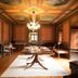 Palacio Torre de Ruesga in Valle, ornate lounge with chandelier, painted ceiling, and central table