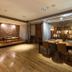 Military 75 Hotel Taichung City lounge with dining table, wooden floors, and illuminated shelves