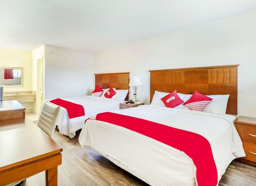 Oyo Hotel San Antonio Lackland AFB/Seaworld Hwy 90 W room with two double beds and red accents