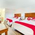 Oyo Hotel San Antonio Lackland AFB/Seaworld Hwy 90 W room with two double beds and red accents