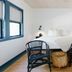 Piety Hill Cottages Nevada City guest room with king bed, two chairs, and wood stump table