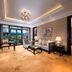 New Century Hotel Guian Guizhou in Anshun: elegant suite with balcony doors, mountain view, and chandelier