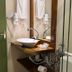 Pousada Charm Canela bathroom vanity with vessel sink, mirror, shower, and decorative tile in Canela