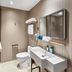 Hanting Harbin Convention and Exhibition Center Hengshan Road Branch bathroom with sink, toilet and mirror