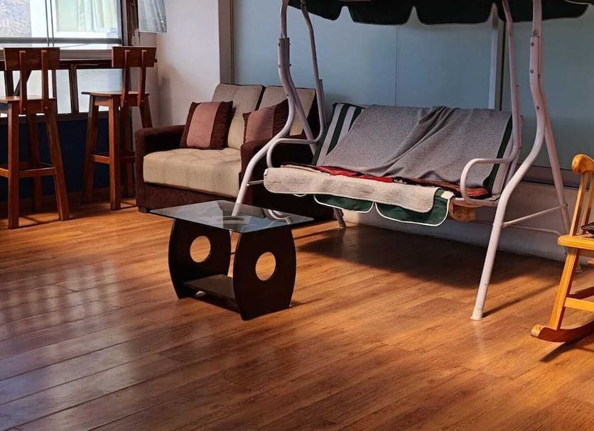 El Mirador de Santa Ana Cusco room with sofa, rocking chair and hanging daybed