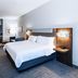 Holiday Inn Express & Suites Dumas by IHG guest room with king bed, TV, desk and chair