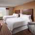Four Points by Sheraton Nashville Airport guest room with two double beds and striped carpet