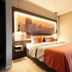 JustStay Mülheim an der Ruhr guest room with double bed and warm backlit headboard in Mülheim