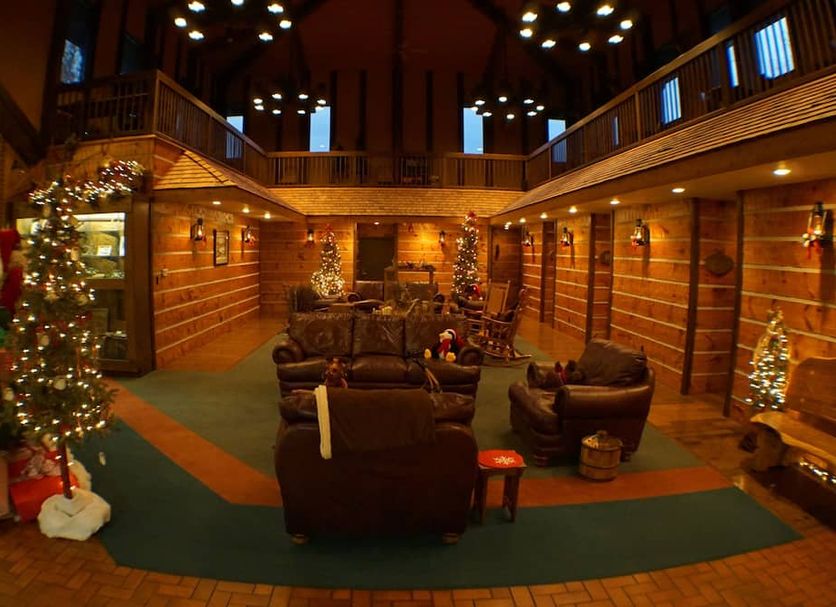 Riverbank Lodge in Petersburg lobby with Christmas tree, wood-paneled lounge seating, and high ceiling