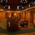 Riverbank Lodge in Petersburg lobby with Christmas tree, wood-paneled lounge seating, and high ceiling
