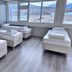 Hunavellir Guesthouse in Blonduos: simple guest room with four single beds and large mountain-view windows