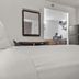 Studio 6 San Luis Obispo CA South room with bed, mirror, mini fridge and microwave