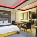 Daegu Innovalley guest room in Daegu with king bed, desk, chairs, mirrored wall and red-lit ceiling