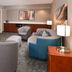Courtyard by Marriott Charlotte Gastonia lobby seating area with chairs, TV, and lamps in Gastonia