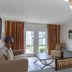 Legacy Vacation Resorts - Lake Buena Vista living room with sofa, TV, and glass doors to a patio