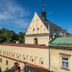 Unikat Guest Rooms Krakow rooftop view of historic buildings and blue sky