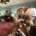 Williamsburg Manor B&B in Williamsburg living room with sofa, red rug, coffee table, lamps, and archways