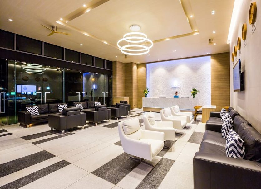 Bluesotel Krabi Aonang Beach lobby seating area with modern lounge chairs and glass entrance in Ao Nang