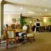 Oakwood Falls Church lobby lounge with seating area, fireplace, and open dining space in Falls Church