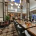 Hilton Garden Inn Auburn Lewiston Riverwatch lobby lounge with long communal tables and seating