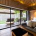 ananea Beyond Khaolak in Takua Pa: airy villa bedroom with sliding glass doors to a private patio and garden