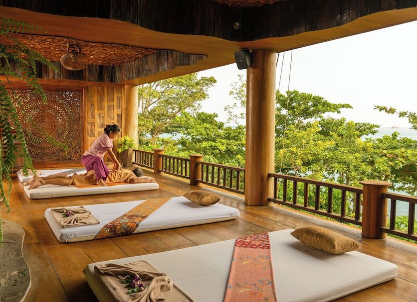 Santhiya Koh Phangan Resort & Spa in Ko Pha Ngan with outdoor spa beds and tropical views