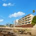 Pacific Edge Hotel in Laguna Beach with oceanfront rooms overlooking a rocky beach and blue sky