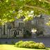 Ashdown Park Hotel & Country Club in East Grinstead, stone manor facade with arched entrance under leafy trees
