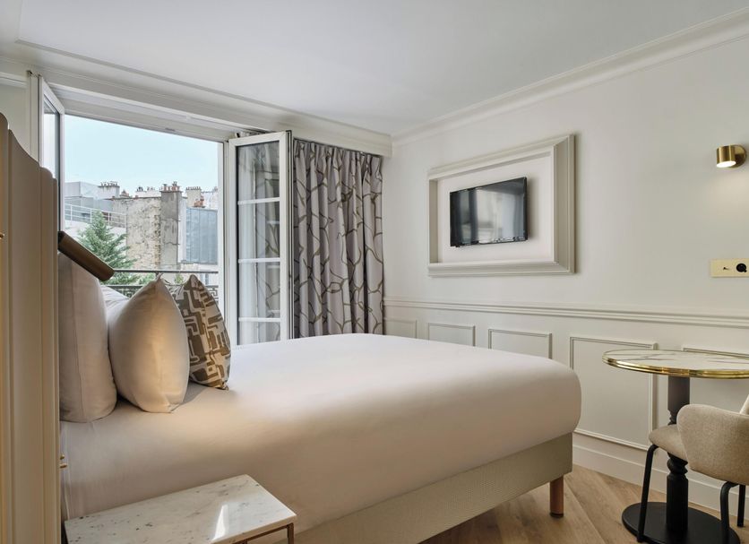 Posy Hotel by Happyculture Paris guest room with open balcony doors and city view