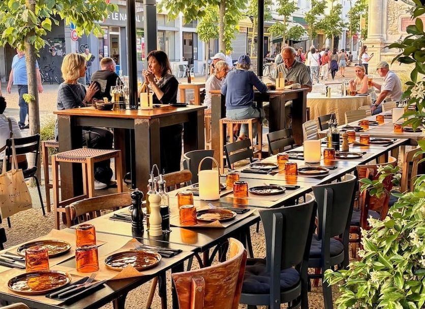 Outdoor dining terrace at Maison Volver in Arles with tables set for guests