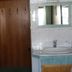 Pension Berggeist in Sölden bathroom with shower, sink, and wooden wardrobe area