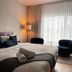 Domaine Belle Plage room in Baie-Saint-Paul with king bed, chairs and large window