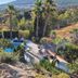 Casa Don Carlos in Alhaurín el Grande with outdoor pool, loungers and palm trees overlooking hills