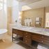Château De Noirieux bathroom in Briollay with freestanding tub, double vanity and large mirror