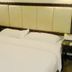 Lvjing International Hotel in Taizhou guest room with bed and padded headboard