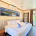 El Galleon Beach Resort in Puerto Galera guest room with king bed, balcony doors and tropical view