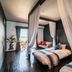 The Beach Terrace Hotel Ao Ishigaki bedroom with canopy bed and balcony view in Ishigaki
