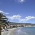 Hotel La Baia in Diano Marina with a palm-lined beach and calm bay view