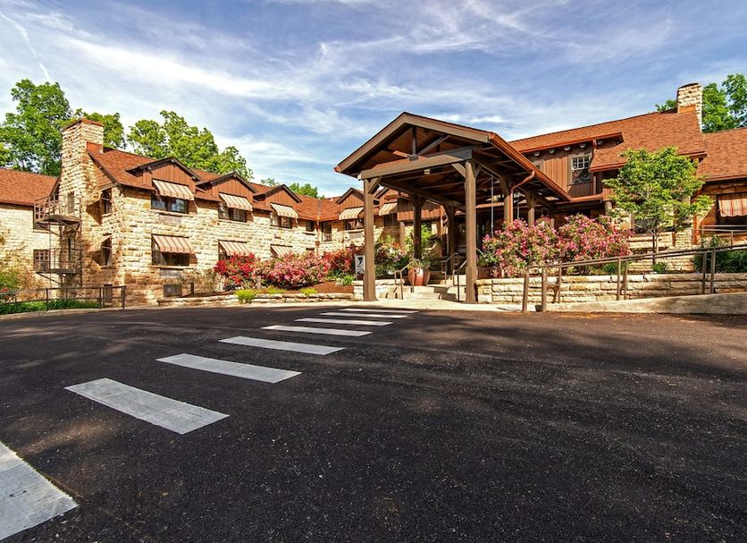 Cumberland Falls State Resort Park in Corbin with a rustic lodge entrance, stone facade, and landscaped grounds