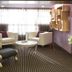 In One City Inn in Taichung City lounge with white sofas, ornate chair, round table and floor-to-ceiling curtains