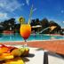 Hotel Santa Gilla in Capoterra: poolside cocktail and fruit plate by the outdoor pool