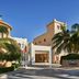 Juweira Boutique Hotel in Salalah entrance with palm trees and blue sky
