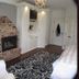 The Connecticut River Valley Inn guest room in Glastonbury with brick fireplace, ornate dresser and patterned rug