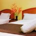 Global Hotel Labuan room with two beds, white linens and folded towels in Labuan