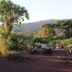 Crater Forest Tented Camp in Karatu with outdoor dining amid lush greenery and hillside views