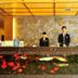 Nan Xiang Hotel - Guiyang front desk with two staff and illuminated fish tank reception counter