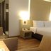 Horison Hotel Sukabumi guest room with double bed, bedside lamps, and seating area in Sukabumi