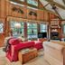 Pine Mountain Club Chalets Resort living room with vaulted wood سقiling, fireplace, and forest views in Pine Mountain