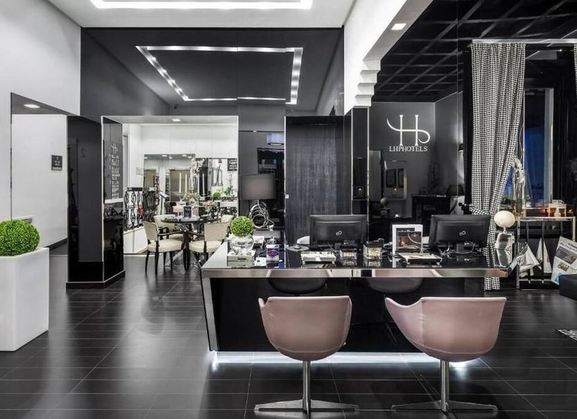 Lhp Hotel River & Spa in Florence lobby with sleek black reception desk and lounge seating