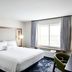 Fairfield Inn & Suites by Marriott Sheboygan guest room with king bed, window, and seating area